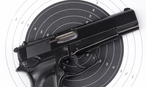 Paper target and gun Paper target and pistol on white