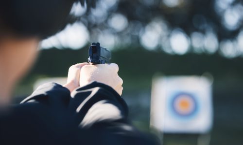 firearm-target-and-person-training-outdoor-at-sho-2023-11-27-05-32-14-utc Firearm, target and person training outdoor at shooting range for game exercise or sports challenge.